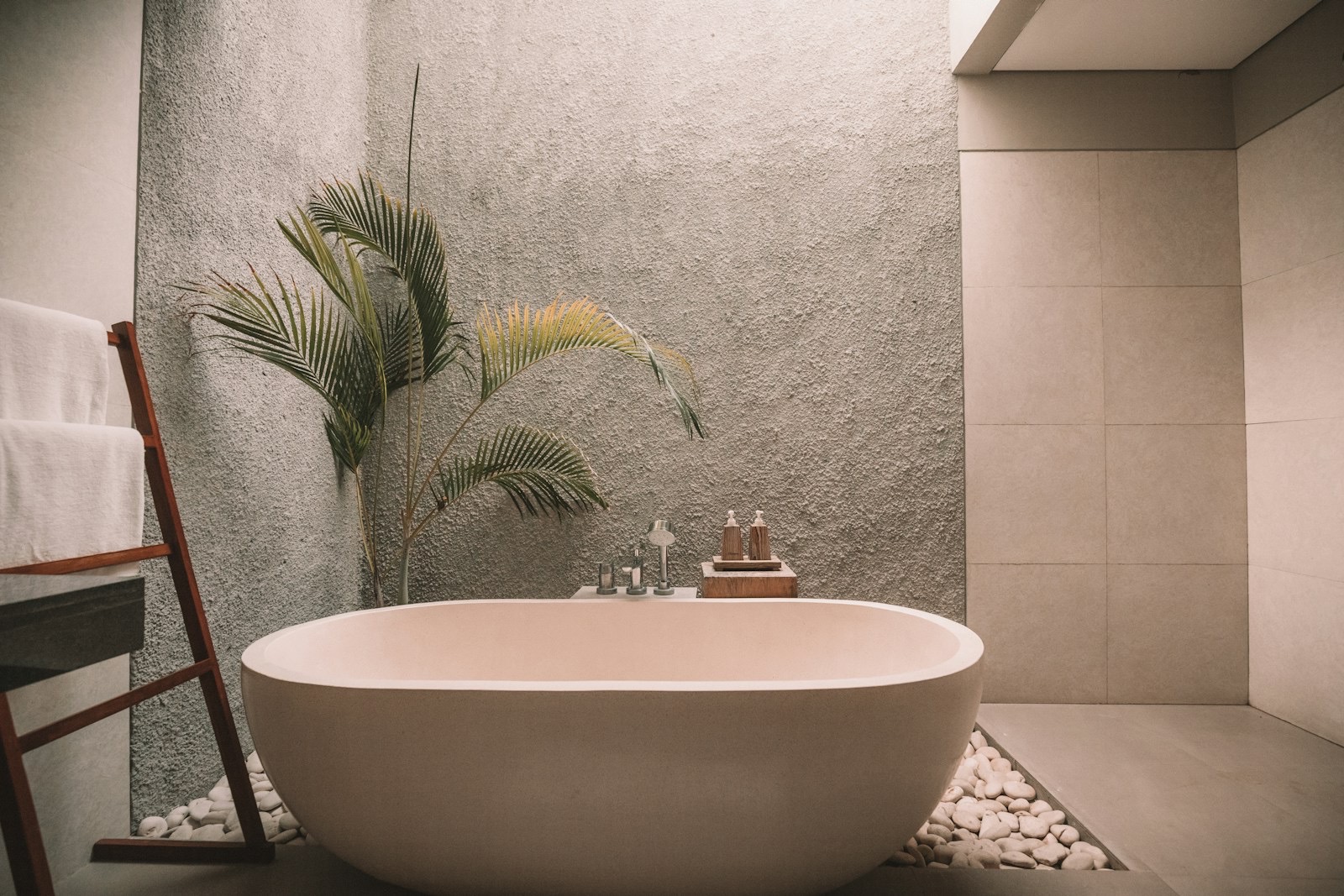 Warm neutral bathroom with a freestanding bath, stock photograph